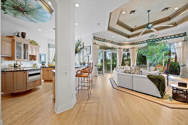 8571 Egret Lakes Ln, West Palm Beach, FL 33412 - living area featuring ornamental molding, a ceiling fan, light wood finished floors, recessed lighting, and a tray ceiling