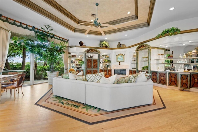 8571 Egret Lakes Ln, West Palm Beach, FL 33412 - living room featuring a ceiling fan, wood finished floors, crown molding, a glass covered fireplace, and recessed lighting
