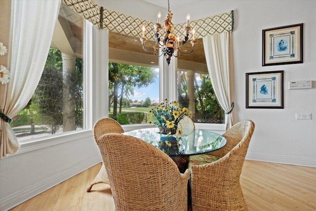 8571 Egret Lakes Ln, West Palm Beach, FL 33412 - dining area with a chandelier and wood finished floors