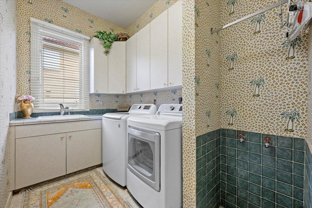 8571 Egret Lakes Ln, West Palm Beach, FL 33412 - washroom with washer and dryer, cabinet space, and tile walls