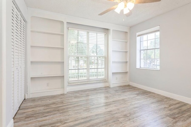 10 Hampton Ct, Palm Beach Gardens, FL 33418 - unfurnished bedroom with wood finished floors, a textured ceiling, and ceiling fan