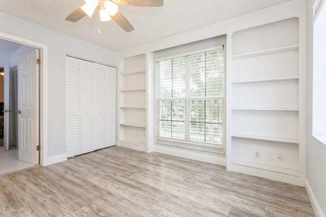 10 Hampton Ct, Palm Beach Gardens, FL 33418 - unfurnished bedroom with wood finished floors, a ceiling fan, and a closet