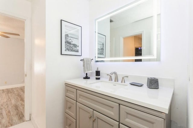 10 Hampton Ct, Palm Beach Gardens, FL 33418 - bathroom featuring vanity, a ceiling fan, and wood finished floors