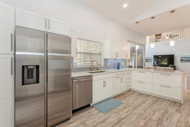 10 Hampton Ct, Palm Beach Gardens, FL 33418 - kitchen featuring stainless steel appliances, light wood-type flooring, tasteful backsplash, light countertops, and white cabinets