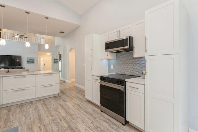 10 Hampton Ct, Palm Beach Gardens, FL 33418 - kitchen featuring stainless steel microwave, electric range, arched walkways, backsplash, and a ceiling fan