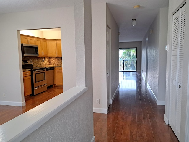 22415 SW 61st Way Unit 204, Boca Raton, FL 33428 - hallway featuring dark wood-type flooring and baseboards