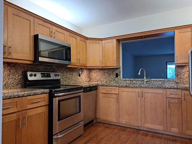 22415 SW 61st Way Unit 204, Boca Raton, FL 33428 - kitchen with appliances with stainless steel finishes, dark stone counters, and decorative backsplash