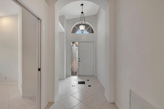 6661 Sherbrook Dr, Boynton Beach, FL 33437 - tiled entryway featuring arched walkways and a chandelier