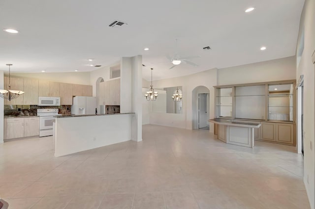 6661 Sherbrook Dr, Boynton Beach, FL 33437 - kitchen featuring white appliances, arched walkways, ceiling fan, tasteful backsplash, and a peninsula