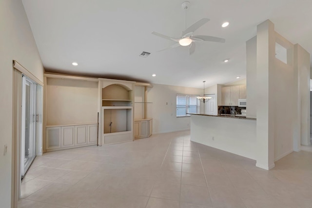 6661 Sherbrook Dr, Boynton Beach, FL 33437 - unfurnished living room featuring a ceiling fan, light tile patterned floors, recessed lighting, a chandelier, and lofted ceiling