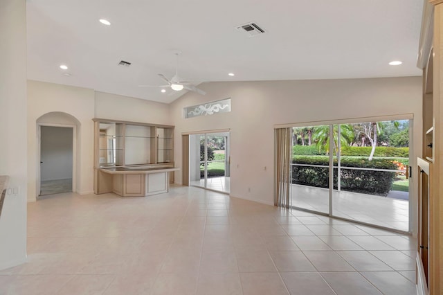 6661 Sherbrook Dr, Boynton Beach, FL 33437 - unfurnished living room featuring ceiling fan, arched walkways, healthy amount of natural light, light tile patterned flooring, and recessed lighting