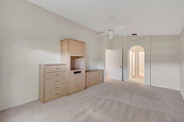6661 Sherbrook Dr, Boynton Beach, FL 33437 - unfurnished bedroom with arched walkways, light colored carpet, connected bathroom, and ceiling fan