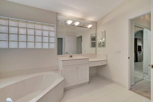 6661 Sherbrook Dr, Boynton Beach, FL 33437 - bathroom featuring a garden tub, vanity, and tile patterned flooring