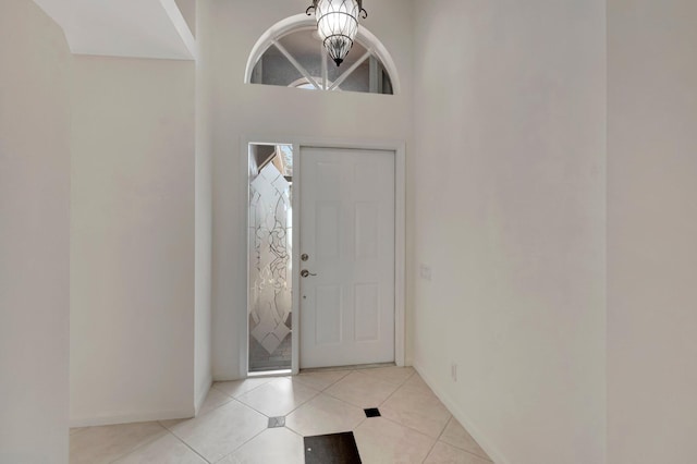 6661 Sherbrook Dr, Boynton Beach, FL 33437 - foyer with light tile patterned floors and a chandelier