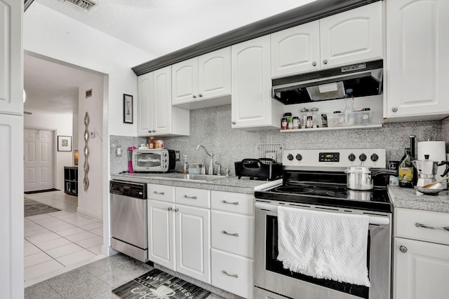461 NW 76th Ave Unit 205, Margate, FL 33063 - kitchen with appliances with stainless steel finishes, extractor fan, light countertops, decorative backsplash, and white cabinets