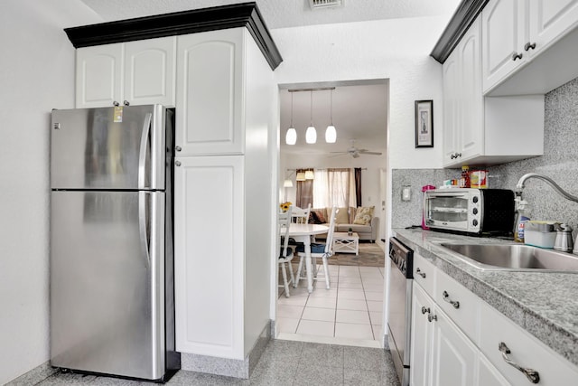 461 NW 76th Ave Unit 205, Margate, FL 33063 - kitchen featuring appliances with stainless steel finishes, white cabinets, light countertops, and backsplash