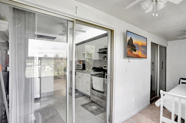 461 NW 76th Ave Unit 205, Margate, FL 33063 - kitchen featuring a ceiling fan, stainless steel appliances, under cabinet range hood, light tile patterned floors, and white cabinets