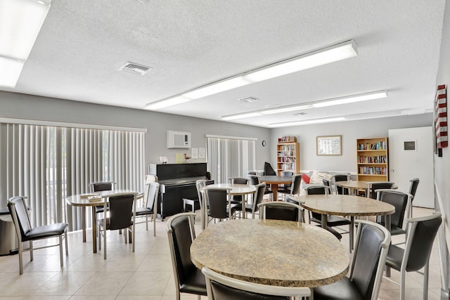 461 NW 76th Ave Unit 205, Margate, FL 33063 - dining area with light tile patterned flooring and a textured ceiling
