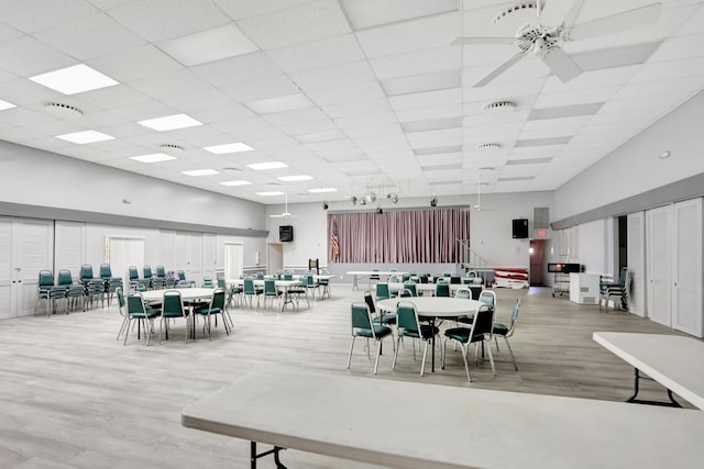461 NW 76th Ave Unit 205, Margate, FL 33063 - dining space with a high ceiling, wood finished floors, a ceiling fan, and a drop ceiling