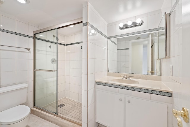 1036 US Highway 1 Unit 318, North Palm Beach, FL 33408 - full bathroom featuring tile walls, a shower stall, vanity, and tile patterned floors