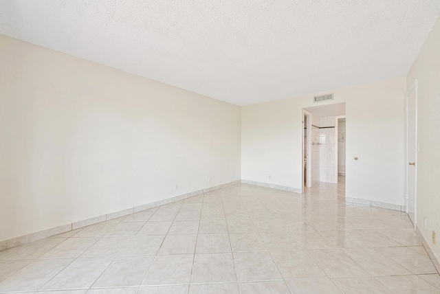 1036 US Highway 1 Unit 318, North Palm Beach, FL 33408 - unfurnished room featuring light tile patterned flooring and a textured ceiling