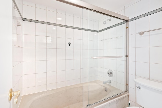 1036 US Highway 1 Unit 318, North Palm Beach, FL 33408 - bathroom featuring combined bath / shower with glass door and tile walls