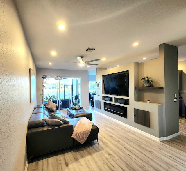 2247 SW Cape Cod Dr, Port Saint Lucie, FL 34953 - living room featuring wood finished floors, recessed lighting, built in features, a ceiling fan, and a textured wall