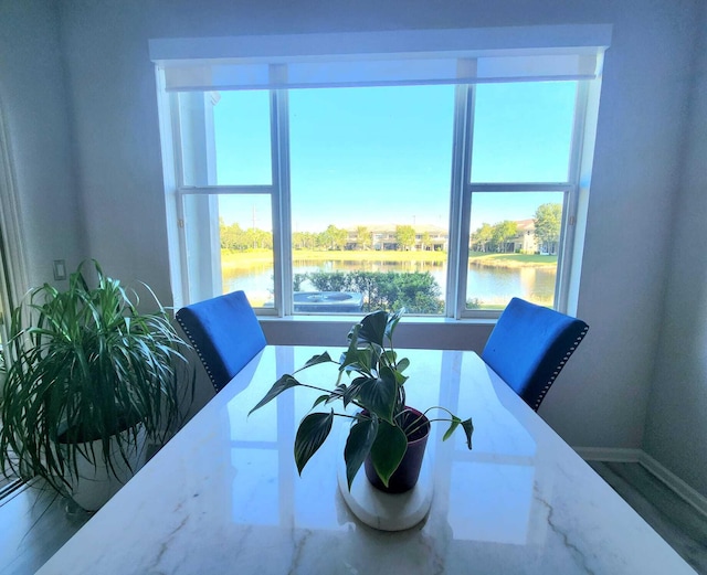 2247 SW Cape Cod Dr, Port Saint Lucie, FL 34953 - dining room featuring a water view and baseboards