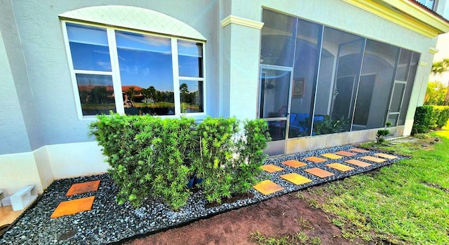 2247 SW Cape Cod Dr, Port Saint Lucie, FL 34953 - view of side of property with a sunroom and stucco siding