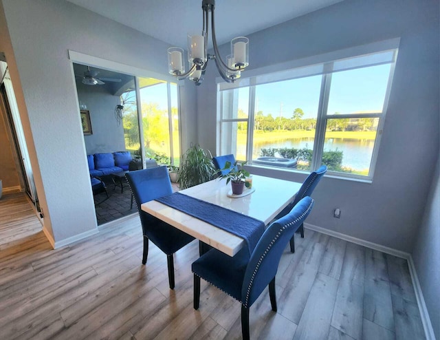 2247 SW Cape Cod Dr, Port Saint Lucie, FL 34953 - dining room featuring a chandelier, wood finished floors, plenty of natural light, and a ceiling fan