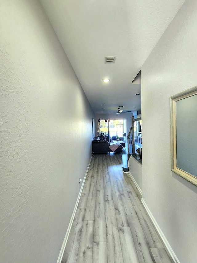2247 SW Cape Cod Dr, Port Saint Lucie, FL 34953 - hall with light wood-style flooring, recessed lighting, and a textured wall