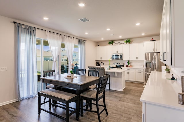 1123 Sugarwood St, Davenport, FL 33837 - dining area featuring light wood-style floors and recessed lighting