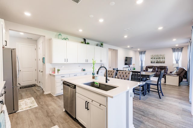 1123 Sugarwood St, Davenport, FL 33837 - kitchen with appliances with stainless steel finishes, light wood-style floors, an island with sink, light countertops, and recessed lighting