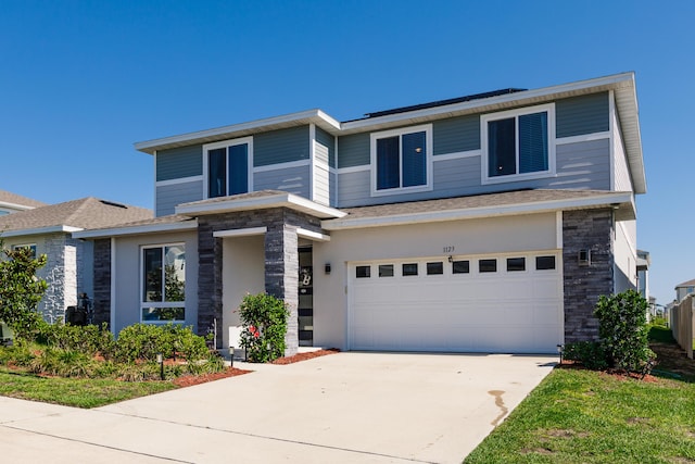 1123 Sugarwood St, Davenport, FL 33837 - view of front of home featuring stone siding, a garage, concrete driveway, and a shingled roof