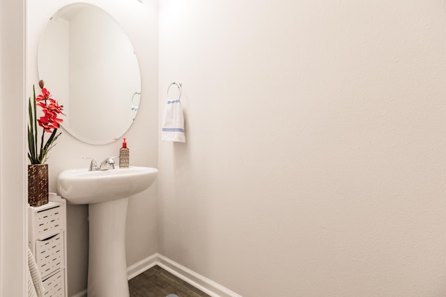 1123 Sugarwood St, Davenport, FL 33837 - bathroom with baseboards and wood finished floors