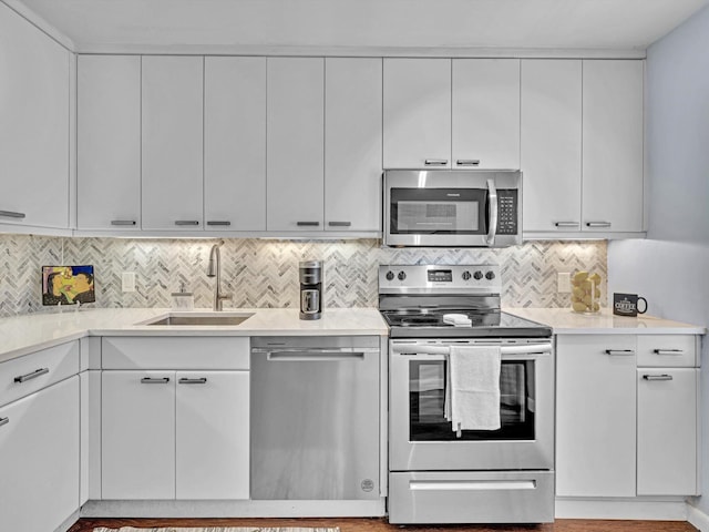 9199 Pecky Cypress Ln Unit 7H, Boca Raton, FL 33428 - kitchen with stainless steel appliances, light countertops, tasteful backsplash, and white cabinets