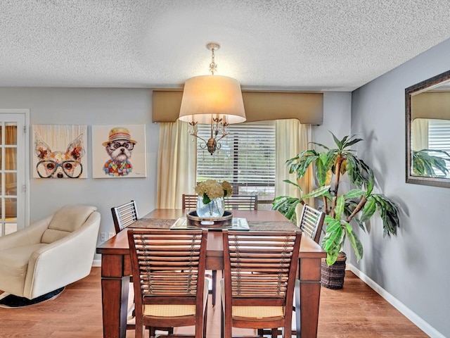 9199 Pecky Cypress Ln Unit 7H, Boca Raton, FL 33428 - dining space featuring wood finished floors and a textured ceiling