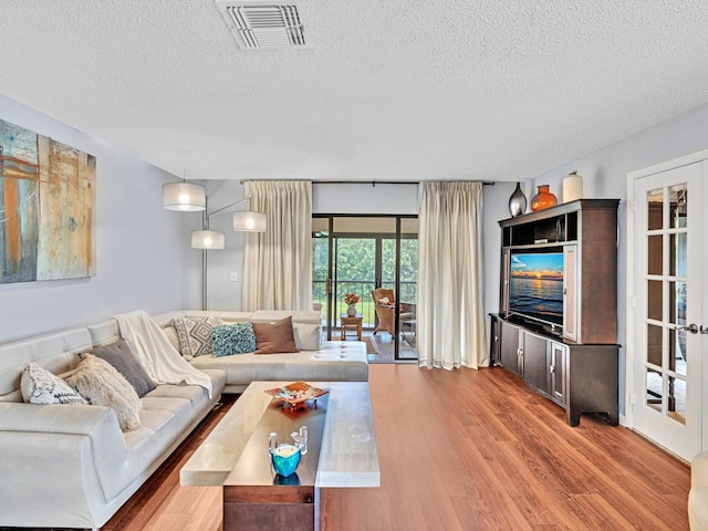 9199 Pecky Cypress Ln Unit 7H, Boca Raton, FL 33428 - living room with a textured ceiling and wood finished floors