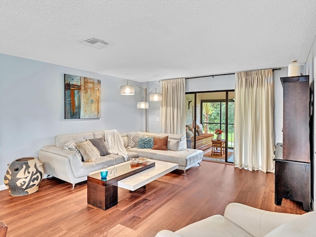 9199 Pecky Cypress Ln Unit 7H, Boca Raton, FL 33428 - living area featuring wood finished floors and a textured ceiling
