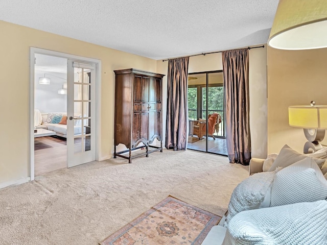 9199 Pecky Cypress Ln Unit 7H, Boca Raton, FL 33428 - living area with carpet flooring, french doors, and a textured ceiling