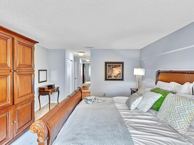 9199 Pecky Cypress Ln Unit 7H, Boca Raton, FL 33428 - bedroom featuring light colored carpet, a textured ceiling, and a closet