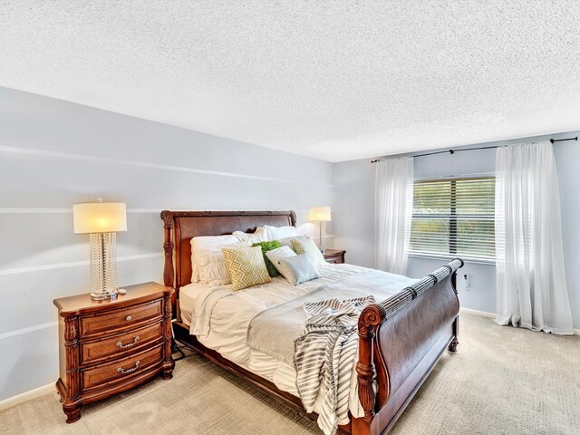 9199 Pecky Cypress Ln Unit 7H, Boca Raton, FL 33428 - bedroom with light colored carpet and a textured ceiling