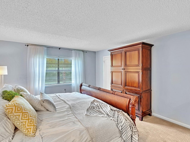 9199 Pecky Cypress Ln Unit 7H, Boca Raton, FL 33428 - bedroom featuring light colored carpet and a textured ceiling