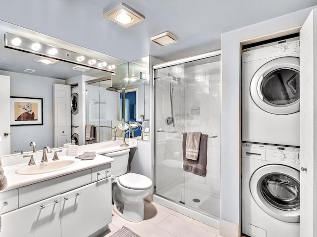 9199 Pecky Cypress Ln Unit 7H, Boca Raton, FL 33428 - bathroom with stacked washing machine and dryer, a shower stall, vanity, and tile patterned floors