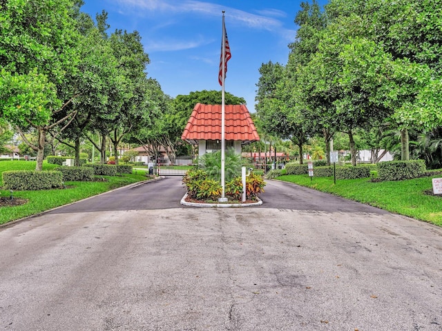 9199 Pecky Cypress Ln Unit 7H, Boca Raton, FL 33428 - view of asphalt road featuring a gate and a gated entry