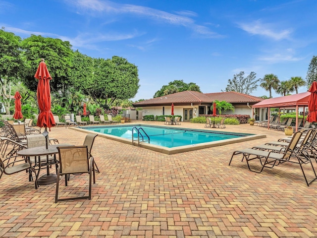 9199 Pecky Cypress Ln Unit 7H, Boca Raton, FL 33428 - community pool with a patio area