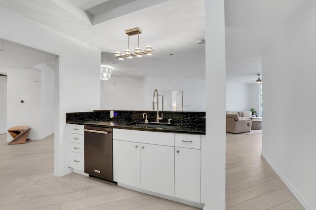 120 Ocean Grande Blvd Unit 302, Jupiter, FL 33477 - kitchen featuring dishwasher, open floor plan, white cabinetry, hanging light fixtures, and dark stone counters