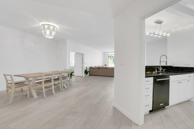 120 Ocean Grande Blvd Unit 302, Jupiter, FL 33477 - kitchen featuring dishwashing machine, light wood-style floors, white cabinetry, and a chandelier