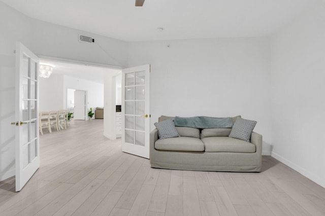 120 Ocean Grande Blvd Unit 302, Jupiter, FL 33477 - living area featuring french doors, wood finished floors, ceiling fan, and vaulted ceiling