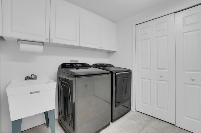 120 Ocean Grande Blvd Unit 302, Jupiter, FL 33477 - laundry room with cabinet space, washer and dryer, and light tile patterned floors